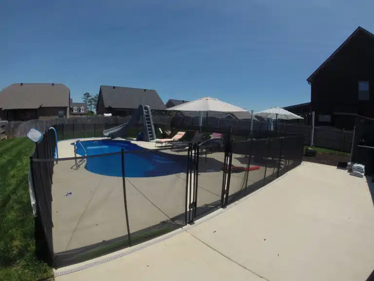 backyard pool with safety fence to demonstrate pool safety