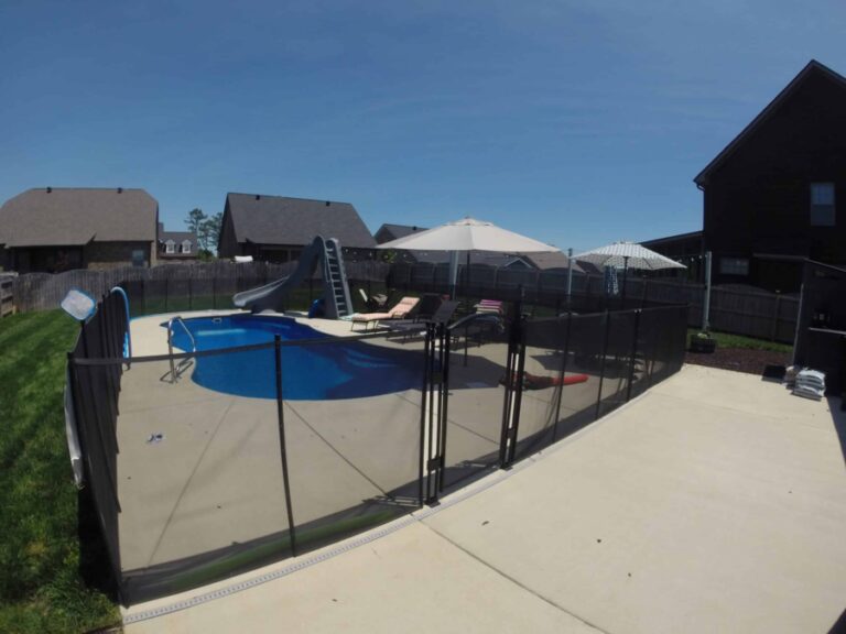 backyard pool with safety fence around the pool