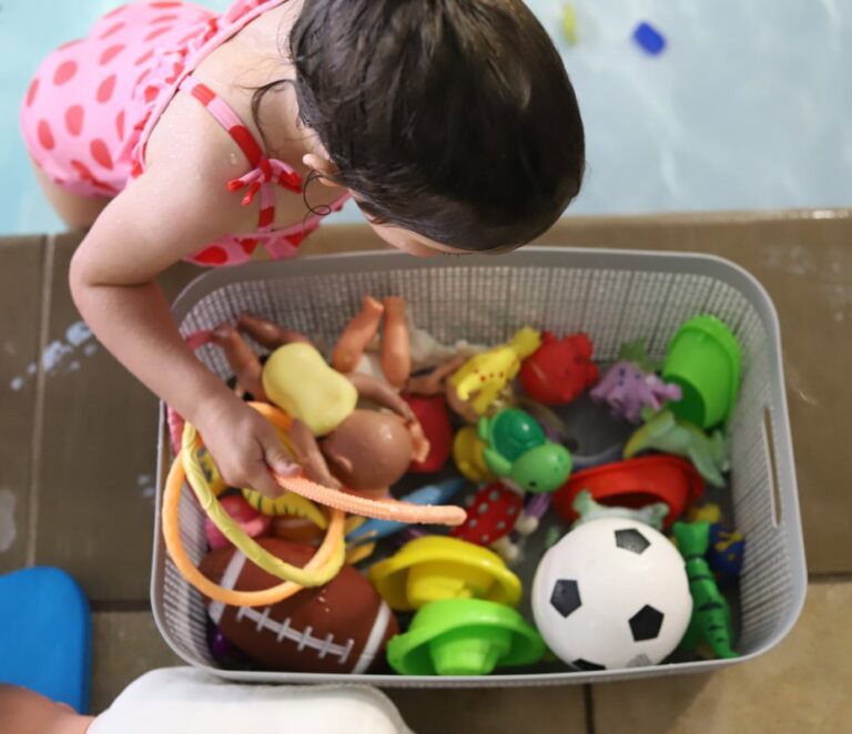 girl playing with toys during swim lessons in knoxville tn