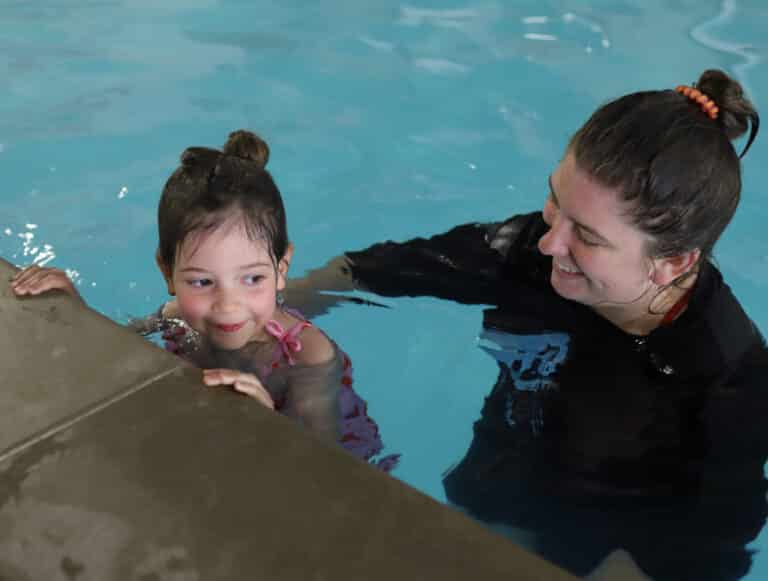 woman swim instructor working with student in knoxville tn